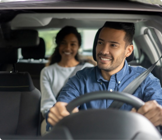 Experienced driver glances at person in backseat.